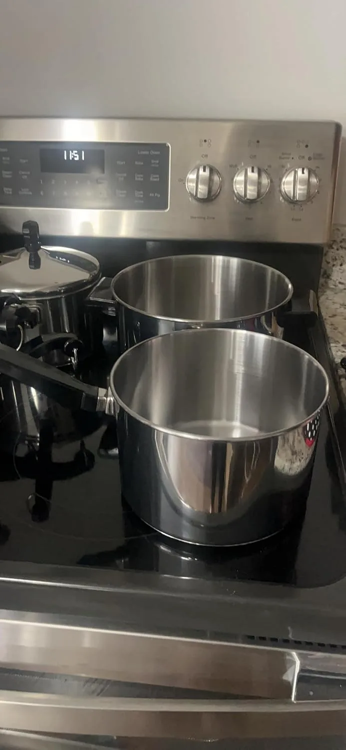Customer photo of stainless steel pots on an electric stove with digital display