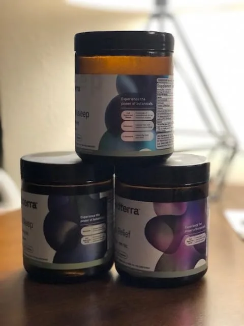 Customer photo of three amber glass jars with black lids containing herbal preparations